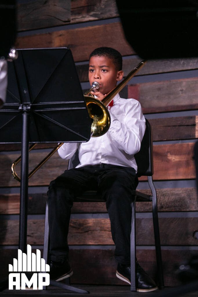 Young student plays trombone at the AMP Center